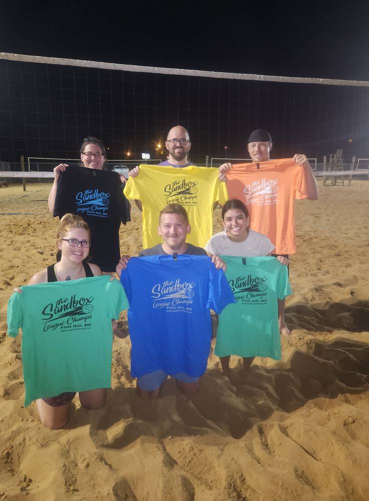 picture of a group of volleyball players wearing the sandbox volleyball logo t-shirts
