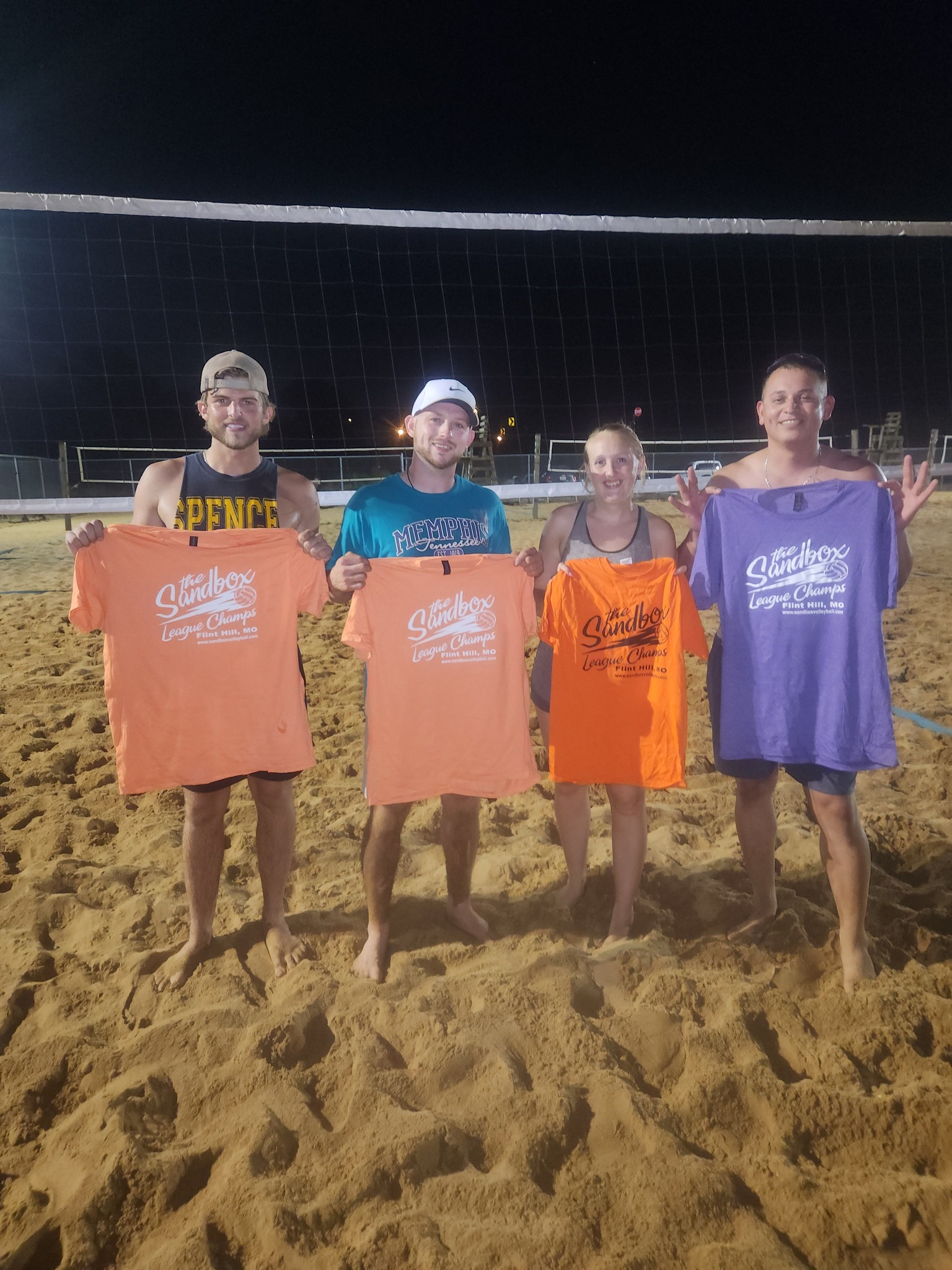 picture of a group of volleyball players wearing the sandbox volleyball logo t-shirts