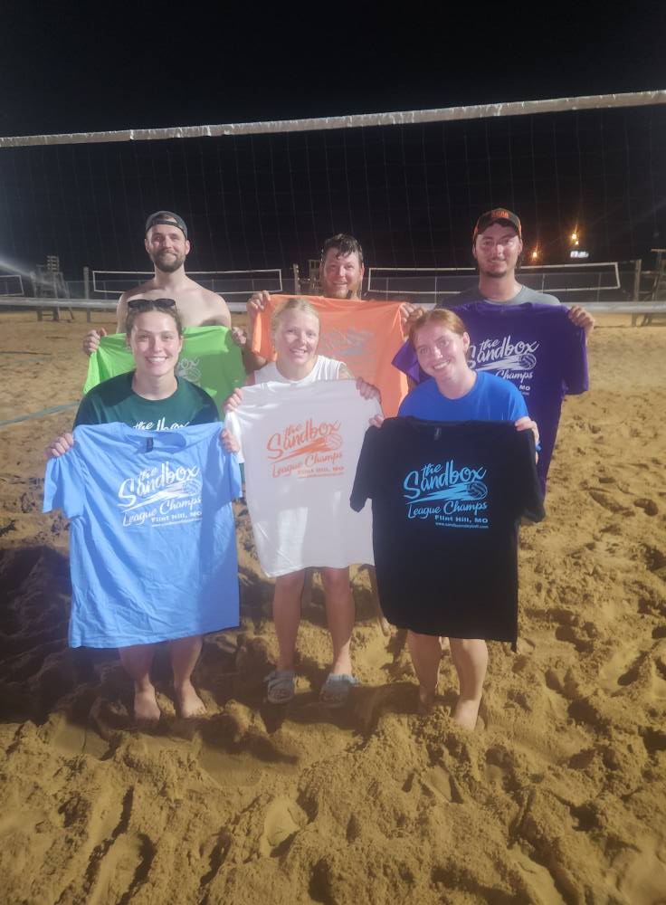 picture of a group of volleyball players wearing the sandbox volleyball logo t-shirts