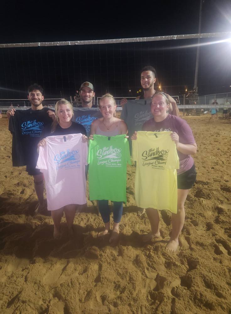picture of a group of volleyball players wearing the sandbox volleyball logo t-shirts