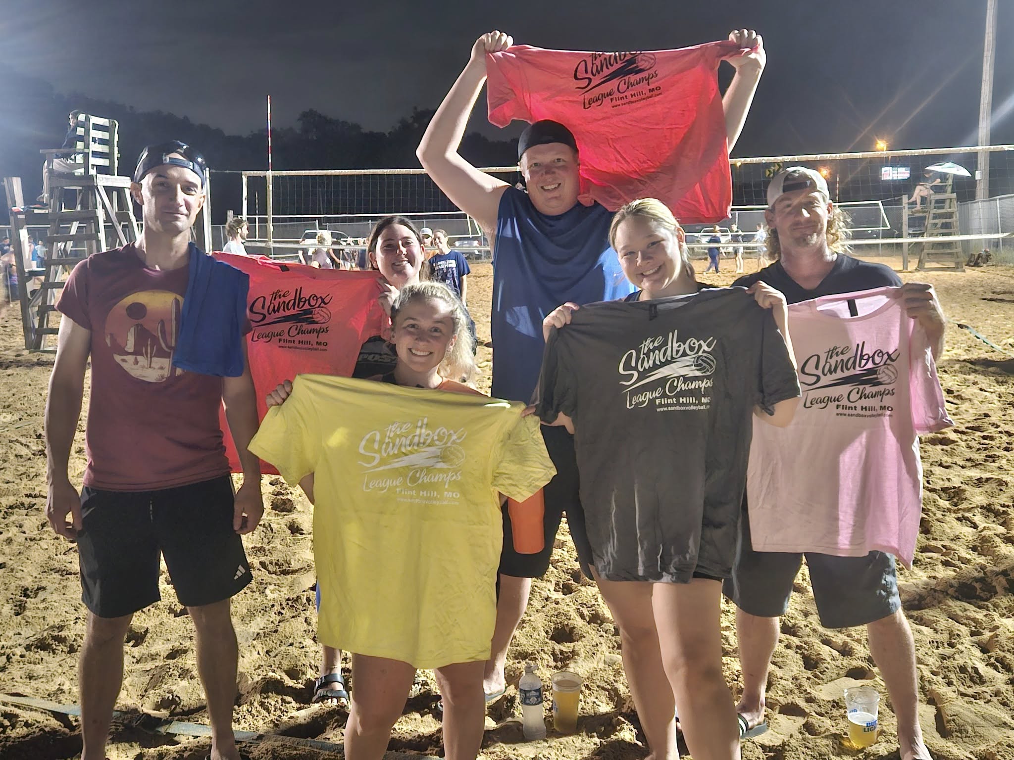 picture of a group of volleyball players wearing the sandbox volleyball logo t-shirts