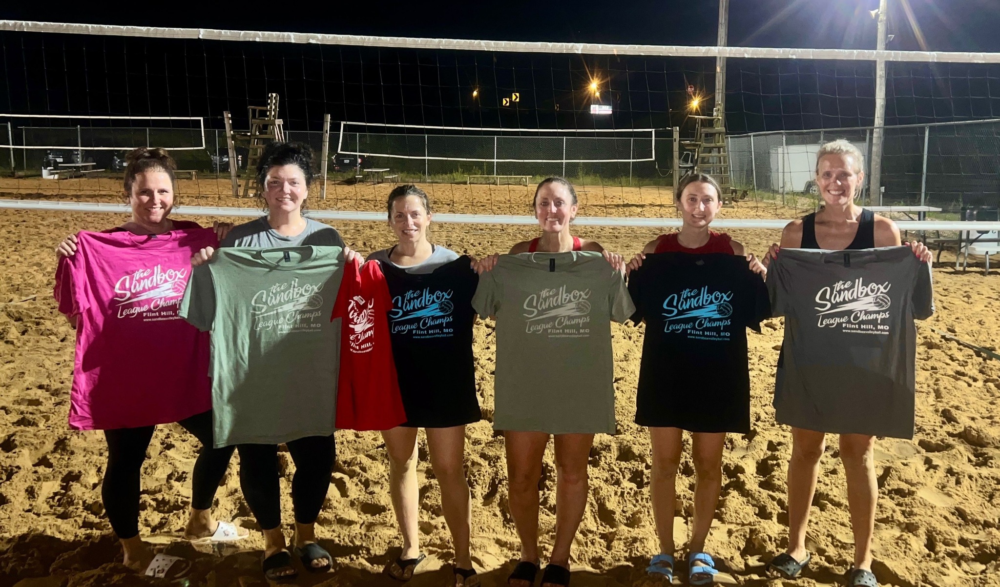 picture of a group of volleyball players wearing the sandbox volleyball logo t-shirts