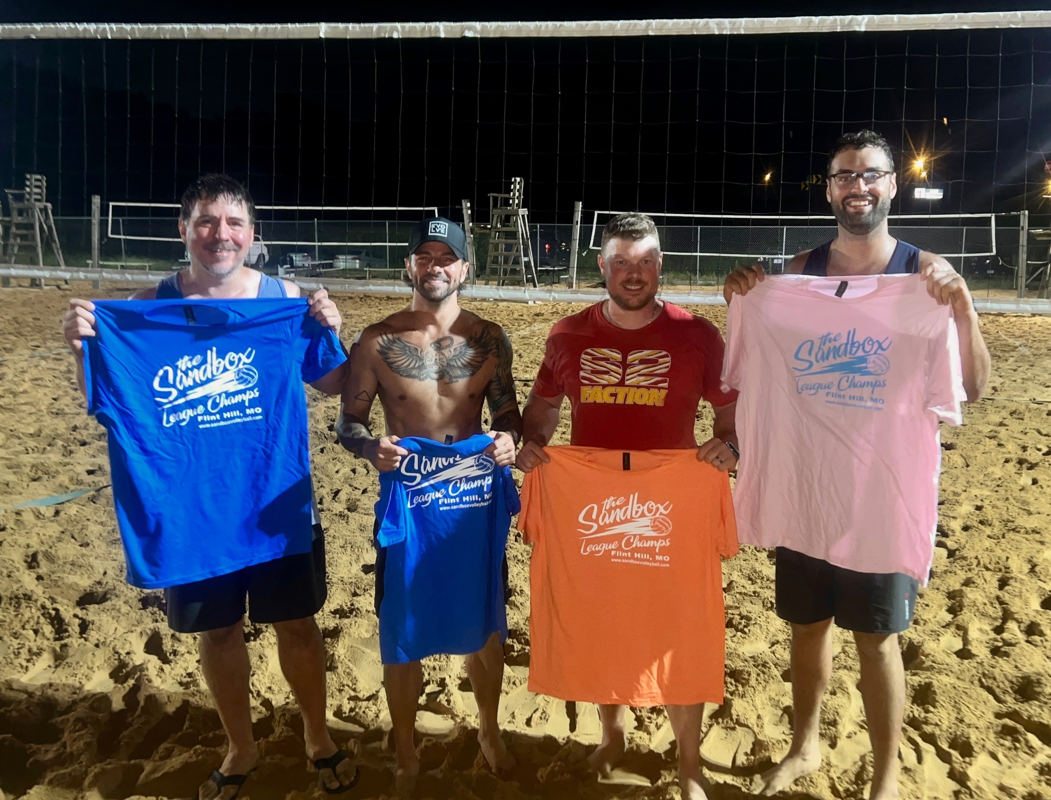 picture of a group of volleyball players wearing the sandbox volleyball logo t-shirts