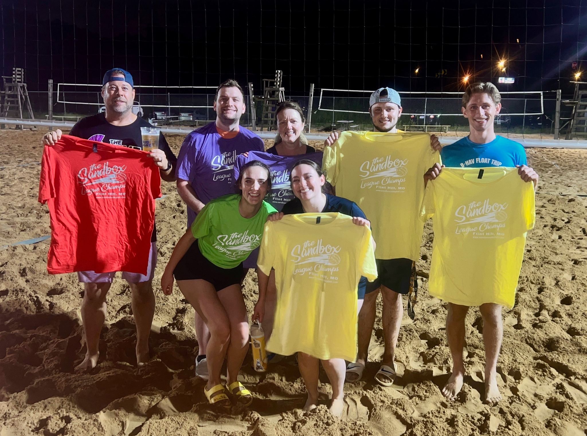 picture of a group of volleyball players wearing the sandbox volleyball logo t-shirts