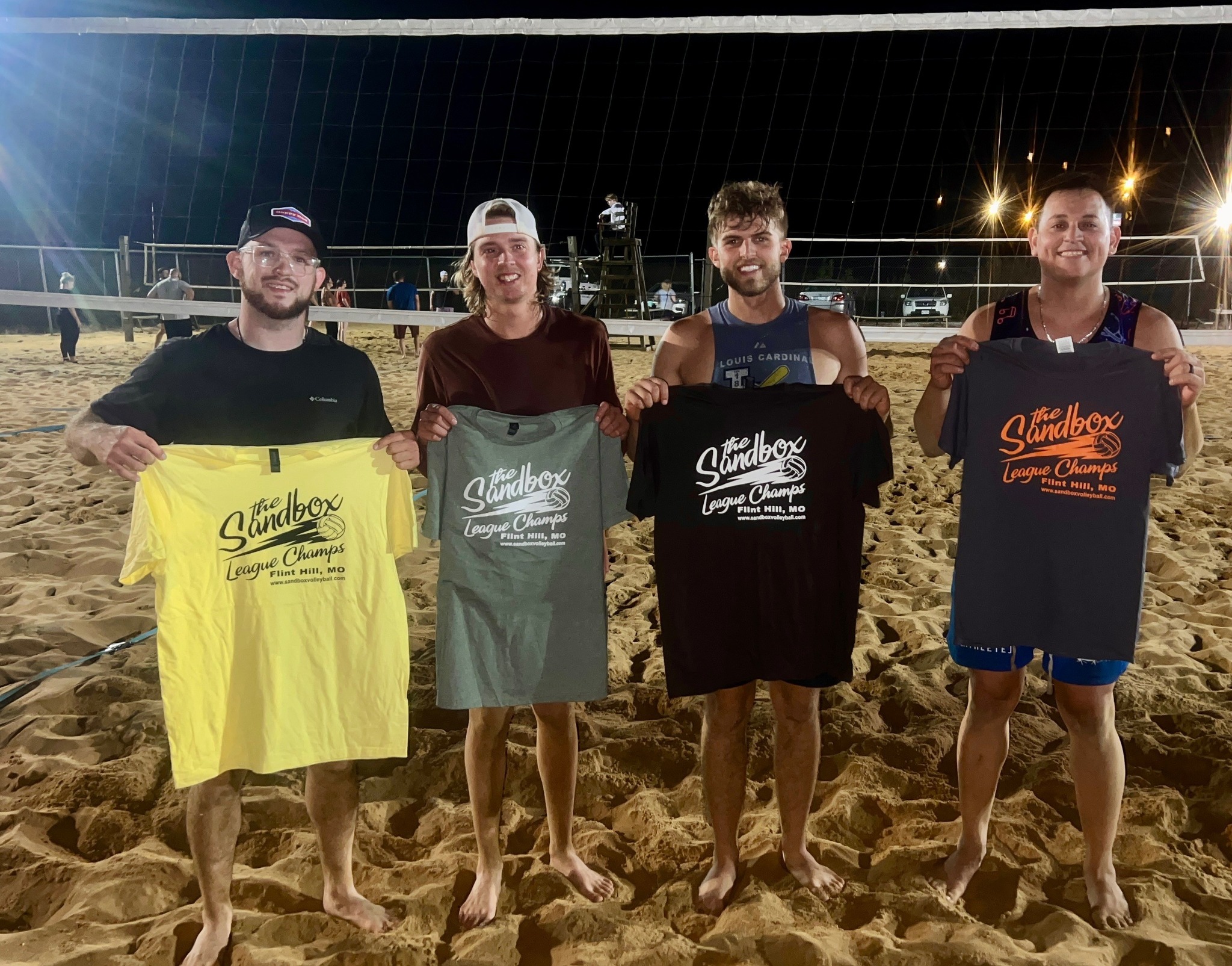 picture of a group of volleyball players wearing the sandbox volleyball logo t-shirts