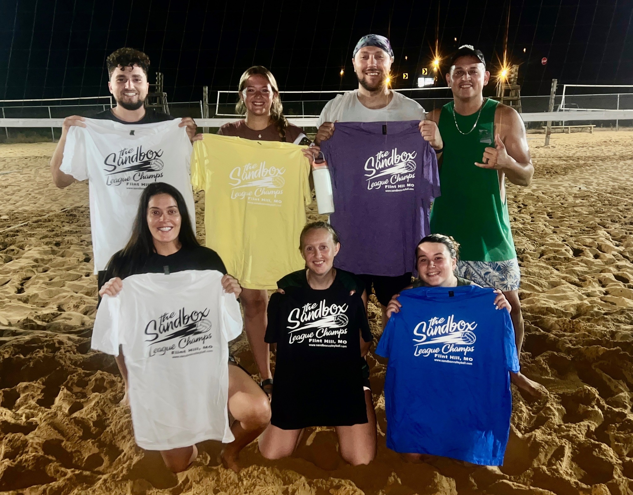 picture of a group of volleyball players wearing the sandbox volleyball logo t-shirts