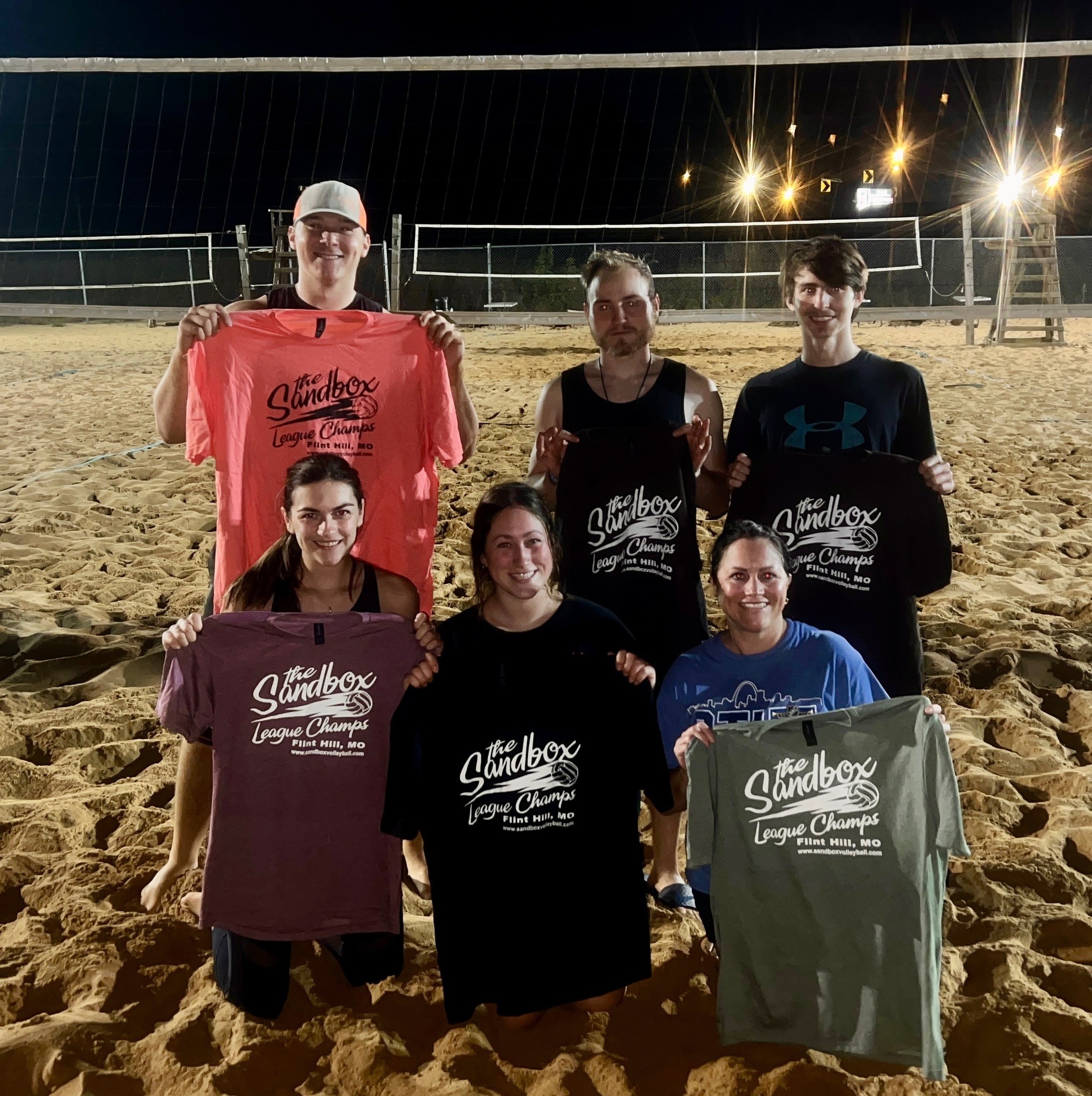 picture of a group of volleyball players wearing the sandbox volleyball logo t-shirts
