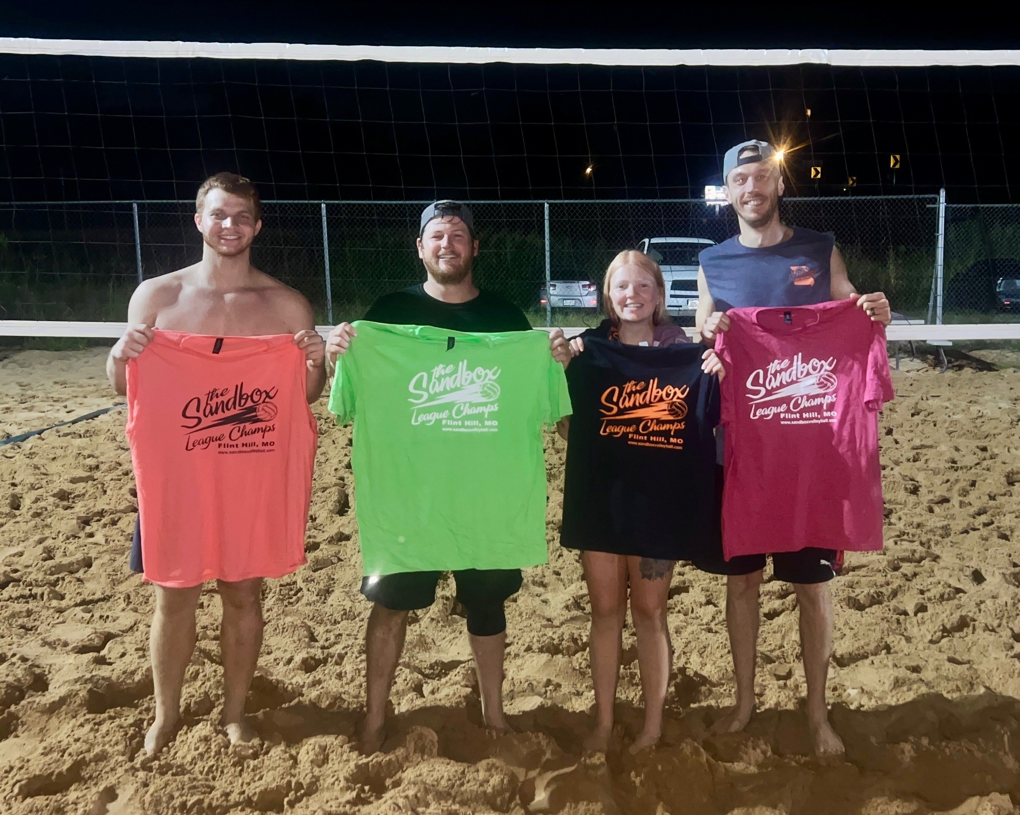 picture of a group of volleyball players wearing the sandbox volleyball logo t-shirts