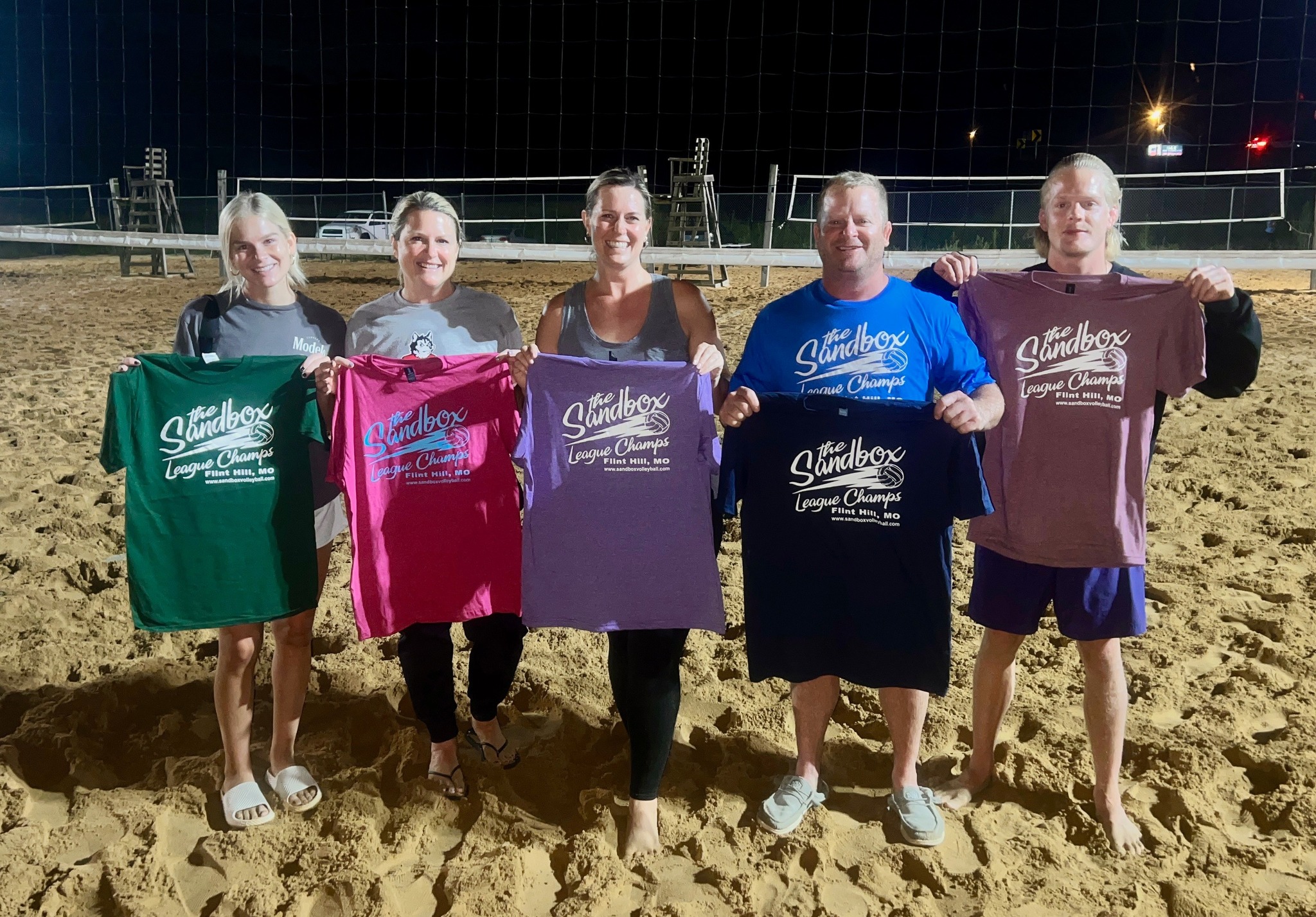 picture of a group of volleyball players wearing the sandbox volleyball logo t-shirts