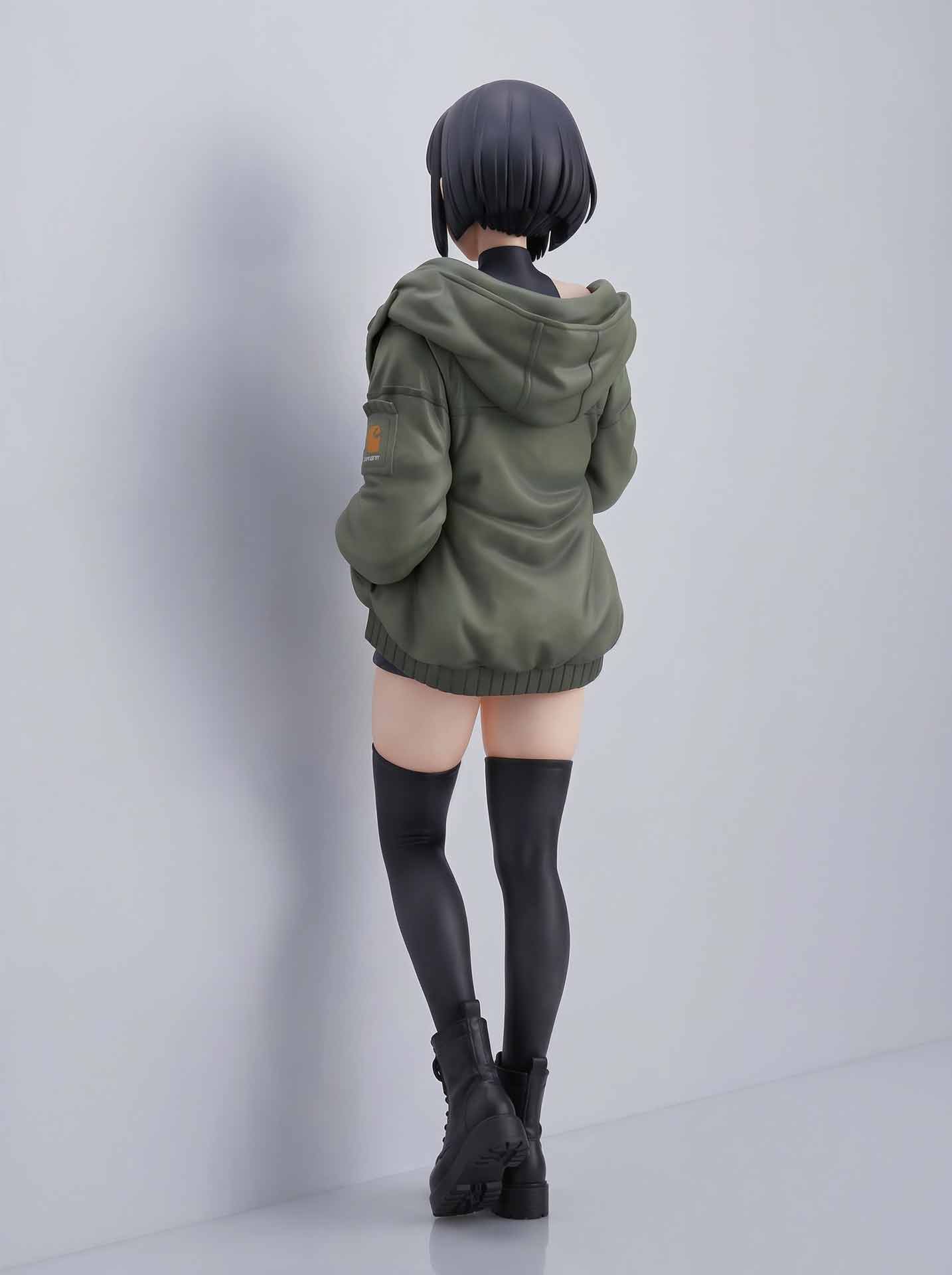 Anime-style figure of a girl with short black hair wearing an oversized green hoodie, thigh-high black stockings, and black boots, standing with her back facing the camera.
