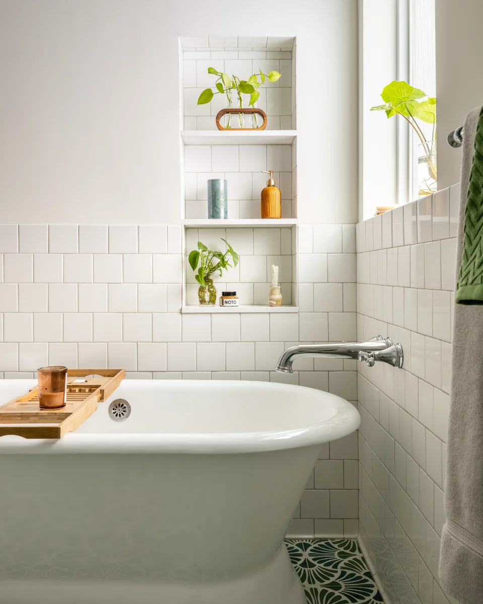 A photo of a SOCO Duo bathroom with a generous white bathtub and tiled built-in shelves