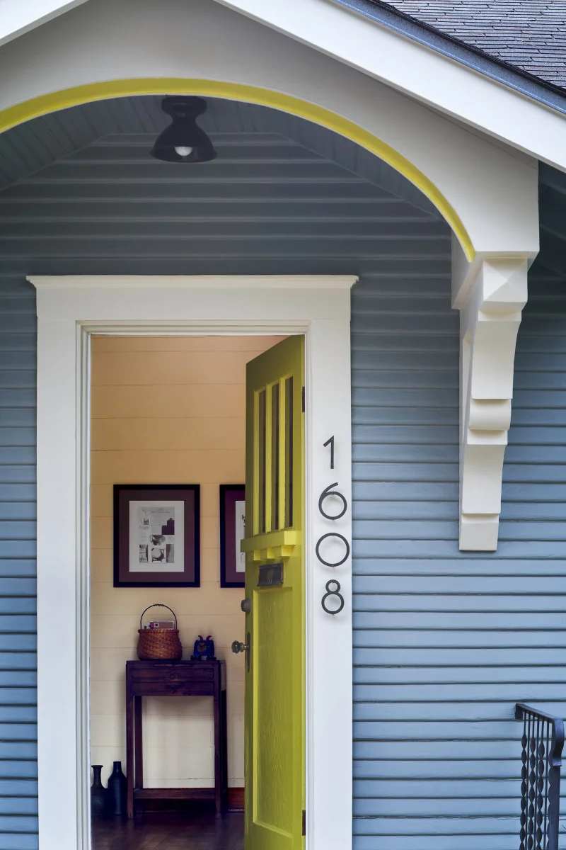 The Wende Bungalow exterior is decorated with slate blue wood panels and chartreuse accents.