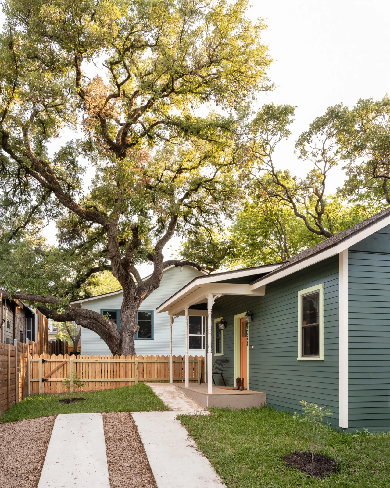 An alternate view of the Back House exterior. A lush green lawn sits in the foreground while an old-growth tree covers the background.