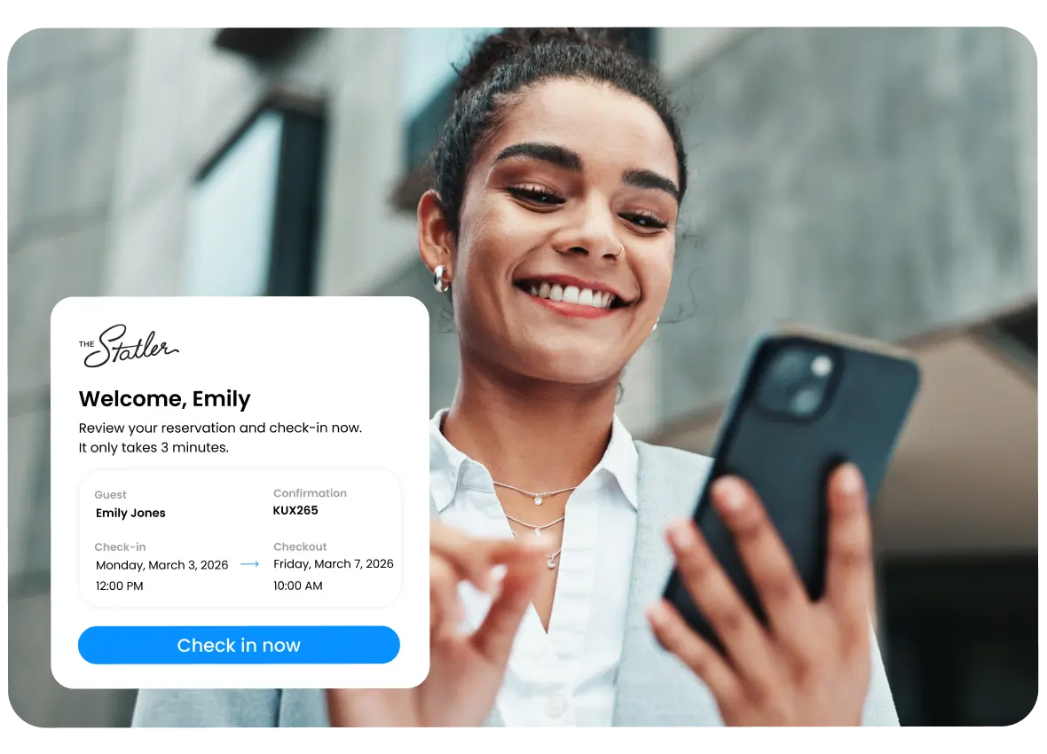 Smiling woman in business attire using her smartphone with a hotel check-in confirmation screen overlay showing guest name Emily Jones and check-in details.