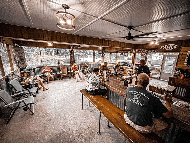 Black and white image of clients enjoying screened in back porch.