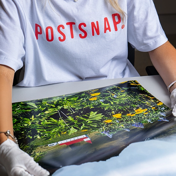 Print technician inspecting personalised poster during quality control check