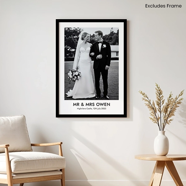 Black and white wedding photo poster displayed on a living room wall