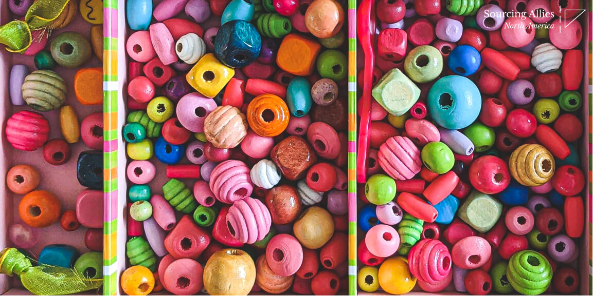 Injection molding- Plastic spoon among set of beads
