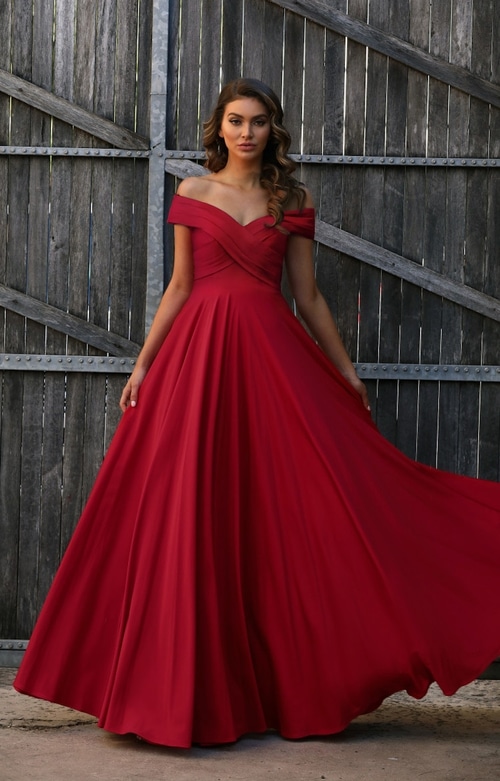 Off the shoulder pleated neckline stretch gown with full skirt.