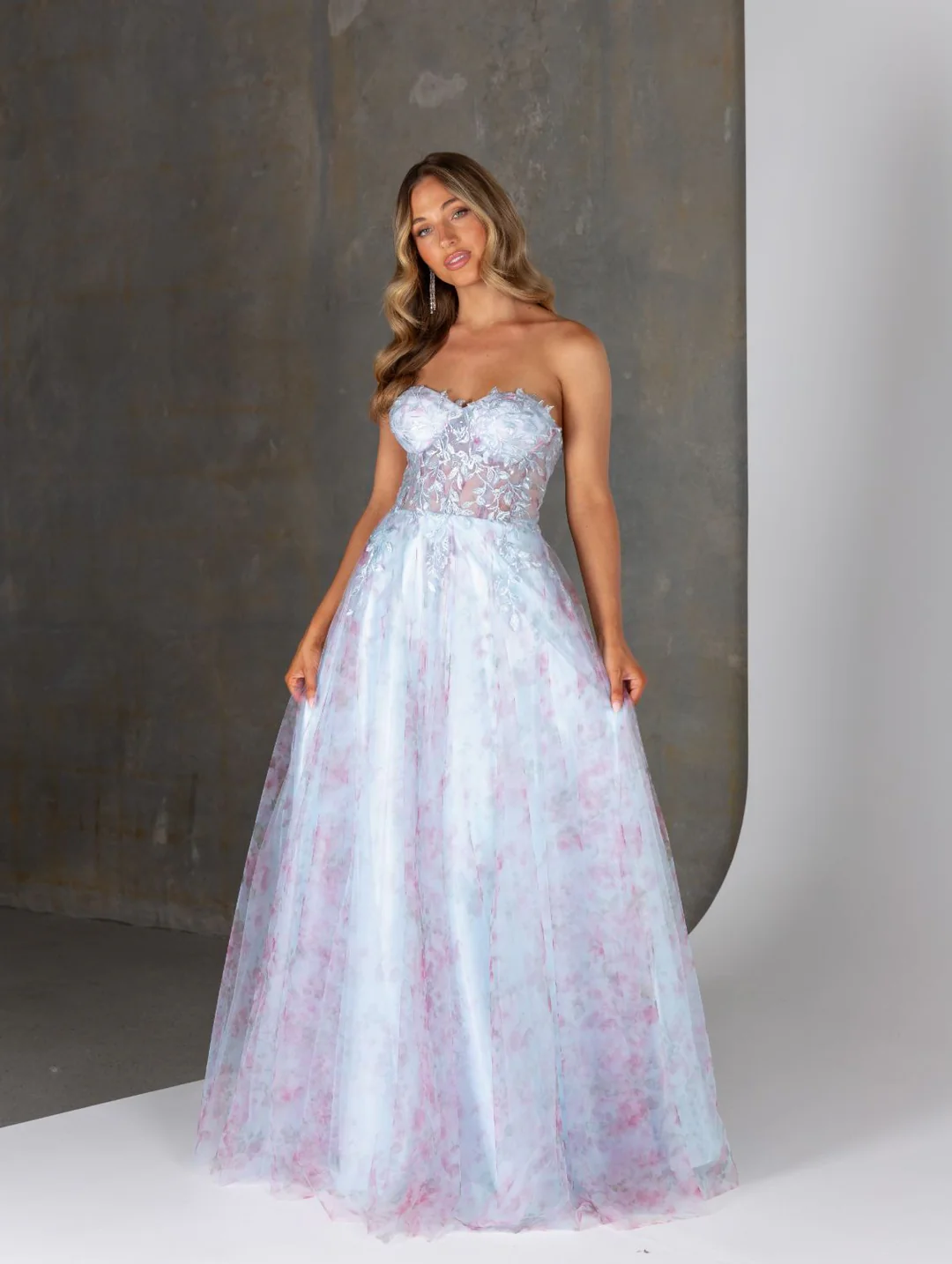 Ethereal and elegant, our Heather strapless formal dress by Tania Olsen Designs is crafted from delicate 3D lace and flowing tulle for a romantic, statement-making look.