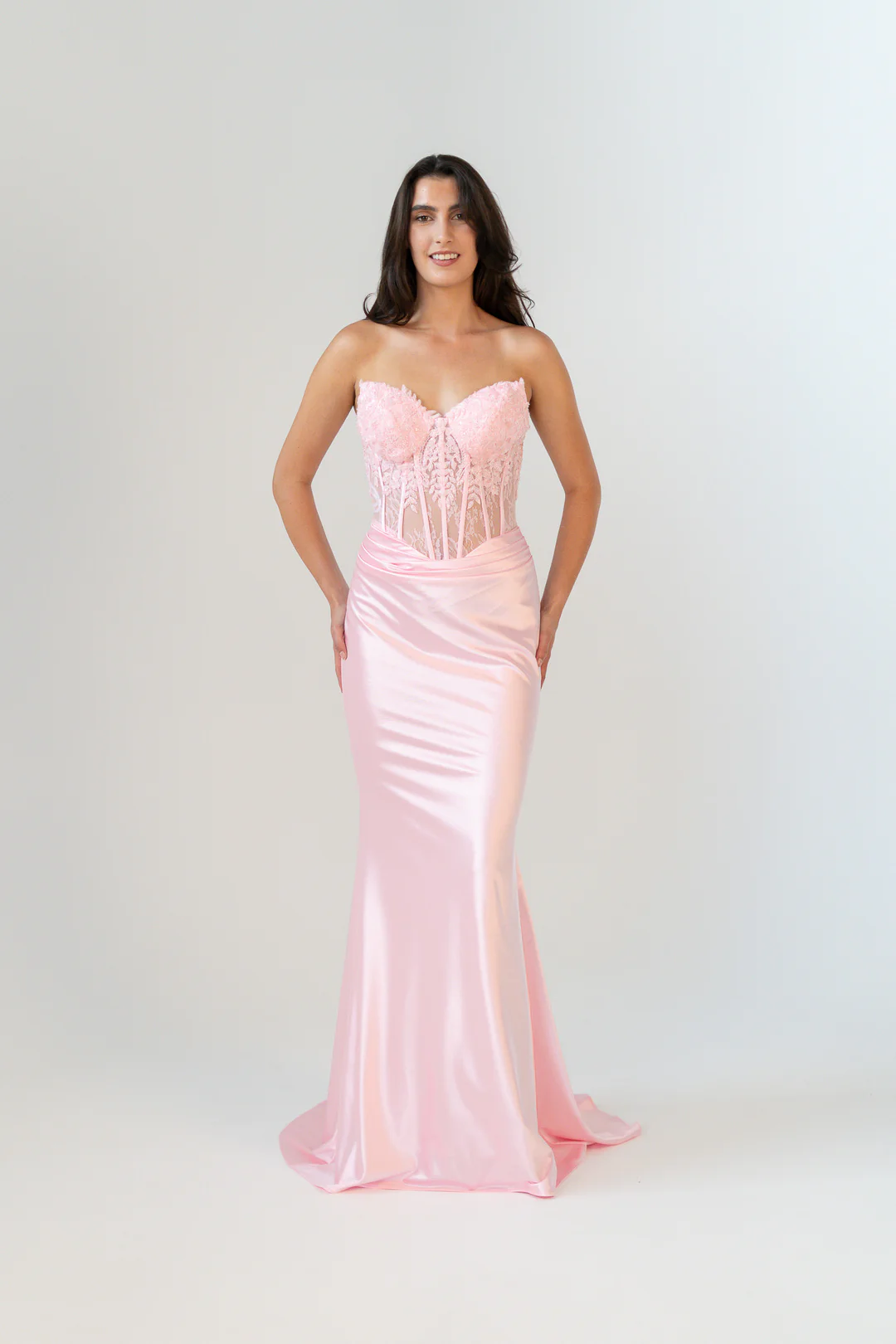 Introducing the Kiki dress, a stunning fusion of elegance and intricate detail. This remarkable piece features a sweetheart peaked neckline complemented by an exposed boned soft lace bodice, adorned with beaded lace appliqué that enhances both the under and over bustline.