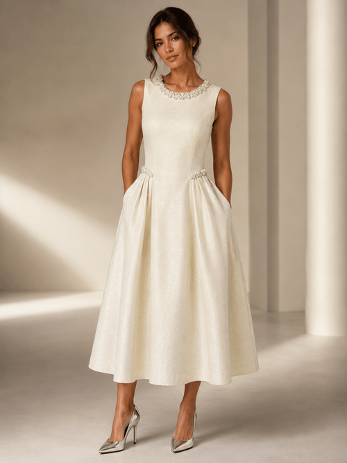 This beautifully tailored dress features a flattering structured A-line silhouette, luxurious textured fabric and delicate pearl and crystal embellishment.