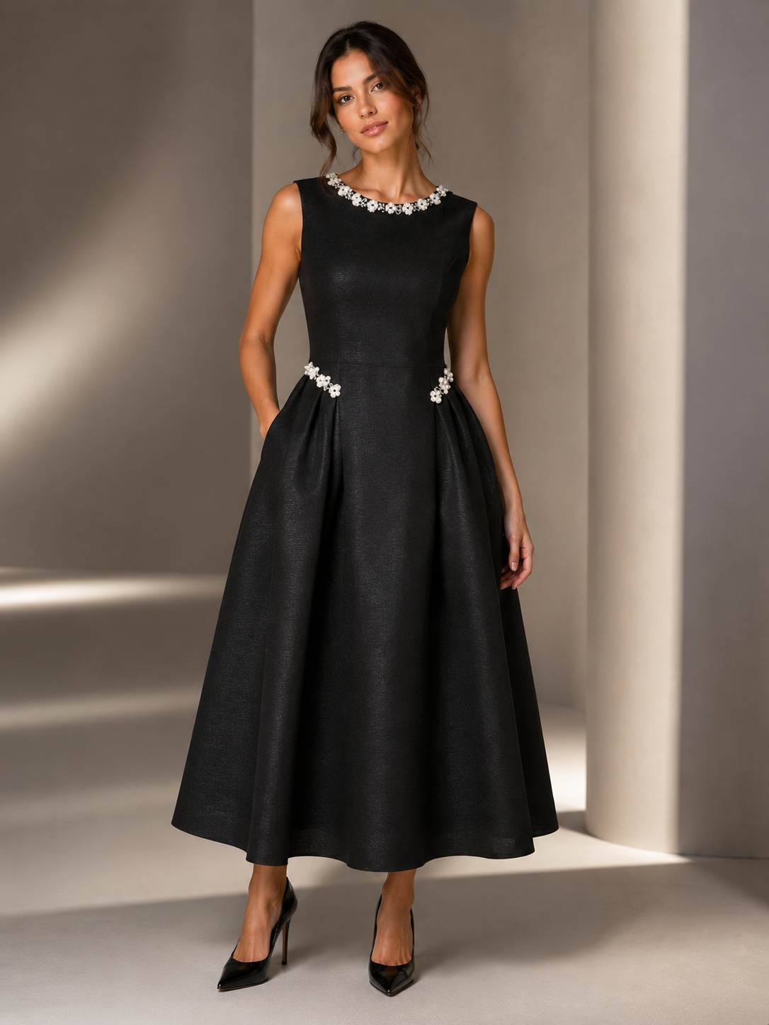 This beautifully tailored dress features a flattering structured A-line silhouette, luxurious textured fabric and delicate pearl and crystal embellishment.