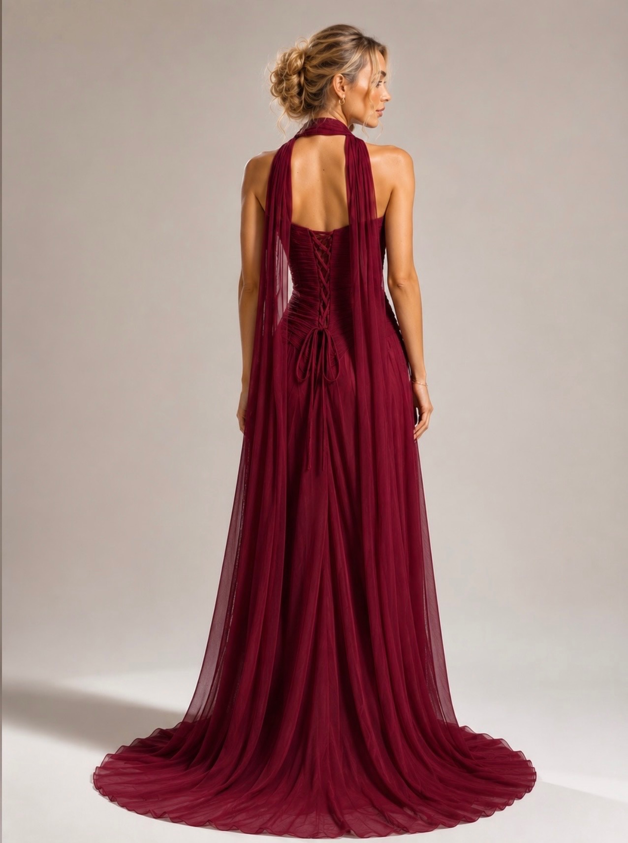 Make a statement in this breathtaking burgundy gown, featuring a beautifully ruched bodice, flattering silhouette, dramatic leg split, and a flowing scarf detail for an extra touch of glamour. Perfect for formals, weddings, galas, and special occasions.