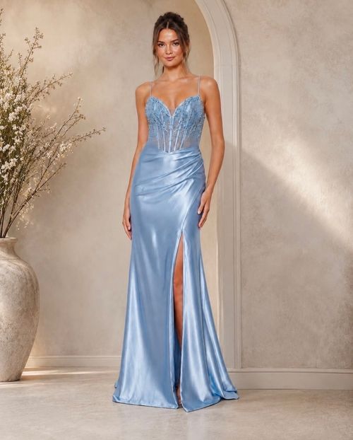 The Carmella Formal Dress is a fitted, full-length gown crafted from stretch satin for a sleek, contoured silhouette. The skirt features a thigh-high split and ruching from one hip, adding movement and flattering definition.