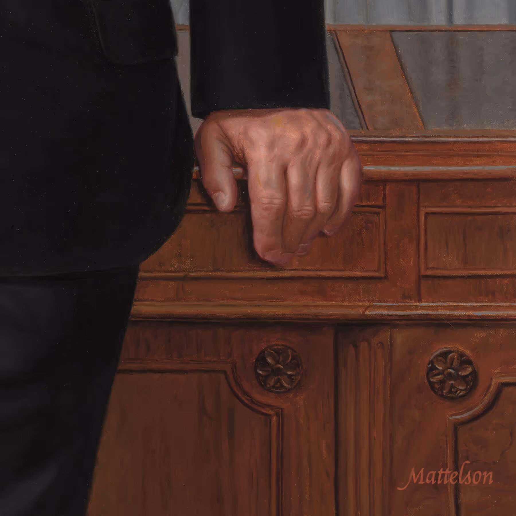 Detail of Robert Cripps’s right hand and the carved woodwork of Sir Humphrey Cripps’s desk.