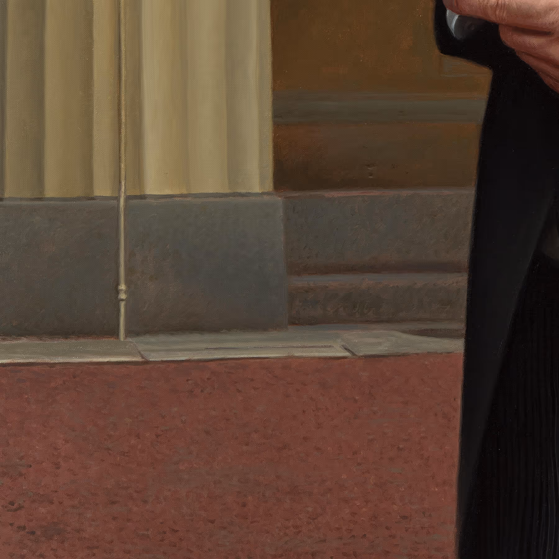 Architectural detail of Buckingham Palace showing the base of a column, stonework, and surrounding ground surface.