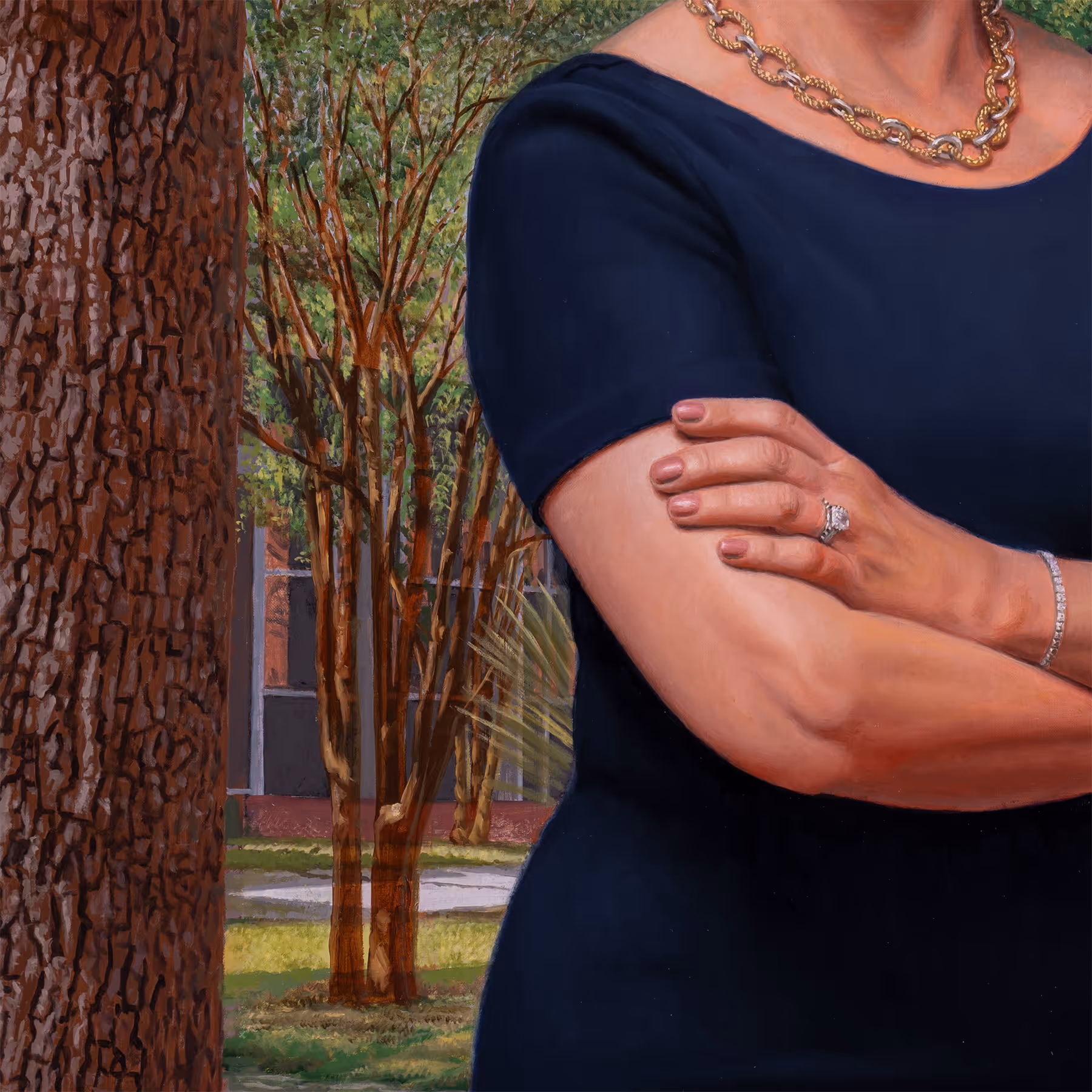 Detail of Julie Johnson beside a large tree trunk in a campus setting.