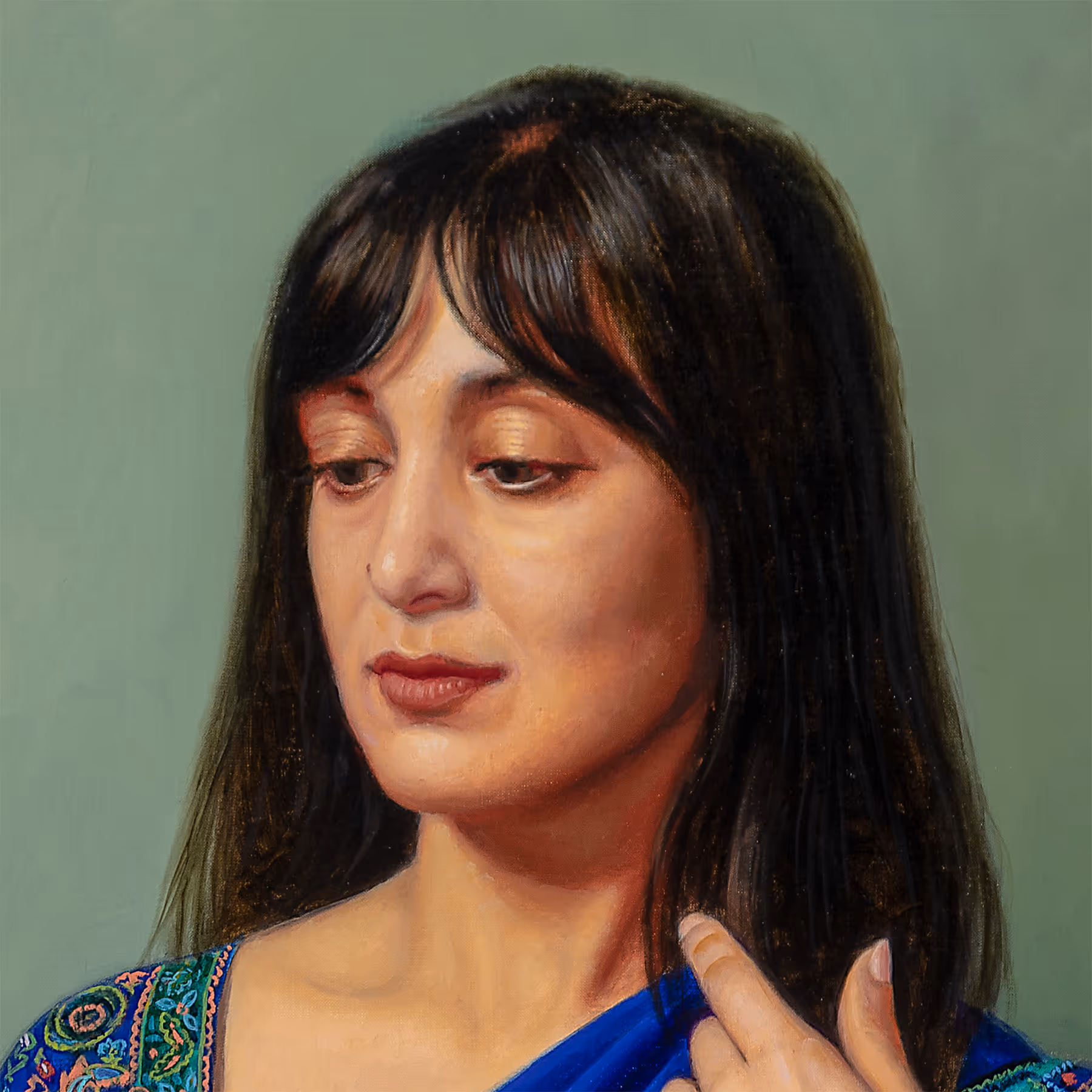 Portrait detail of Noor showing contemplative expression, dark hair, and soft directional lighting.