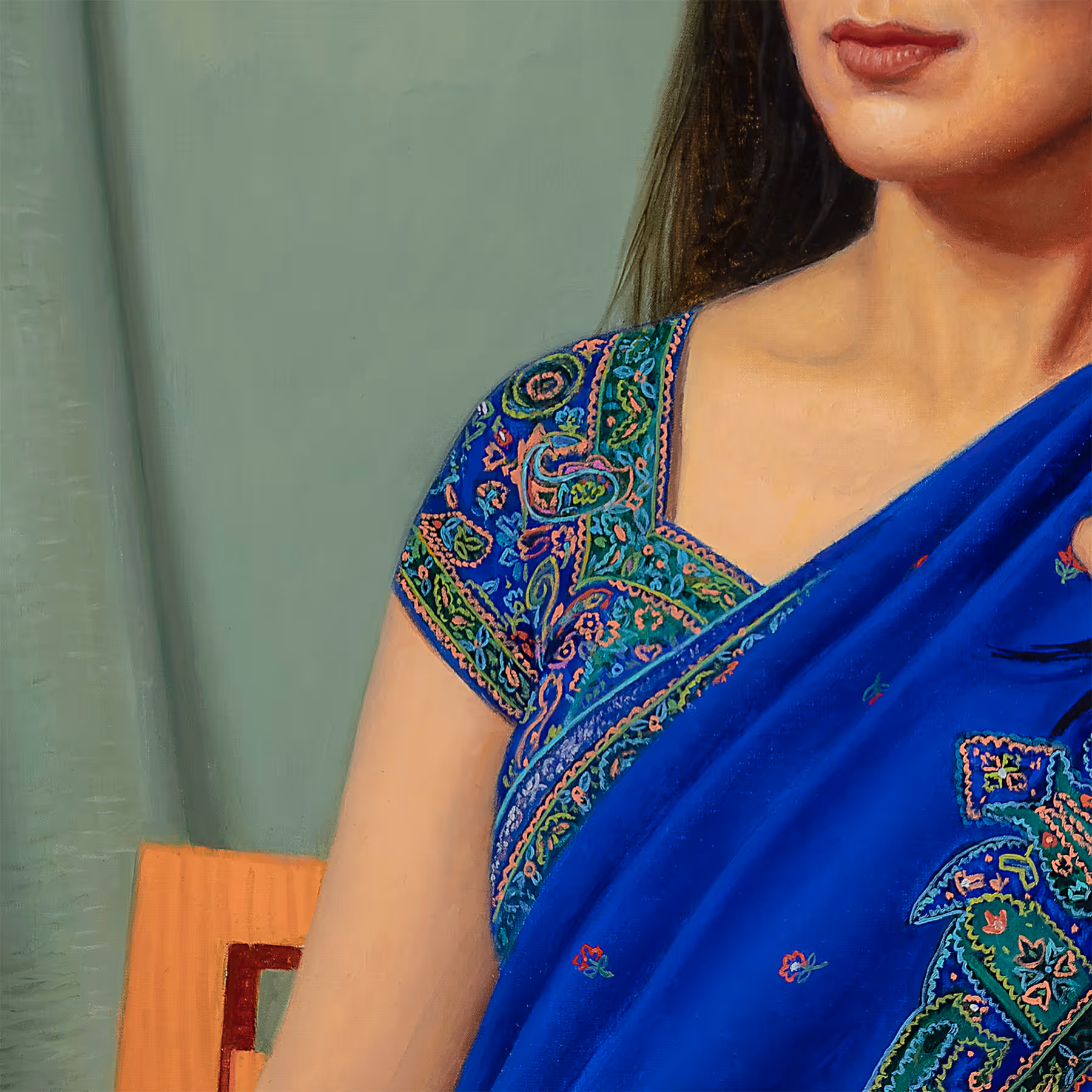 Detail of Noor’s embroidered blue sari showing intricate decorative patterns and painted fabric textures.