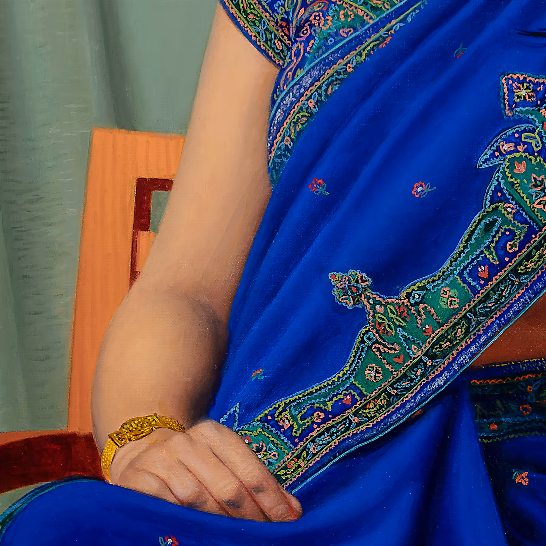 Detail of Noor’s arm and blue sari showing decorative textile patterns and compositional color contrasts.