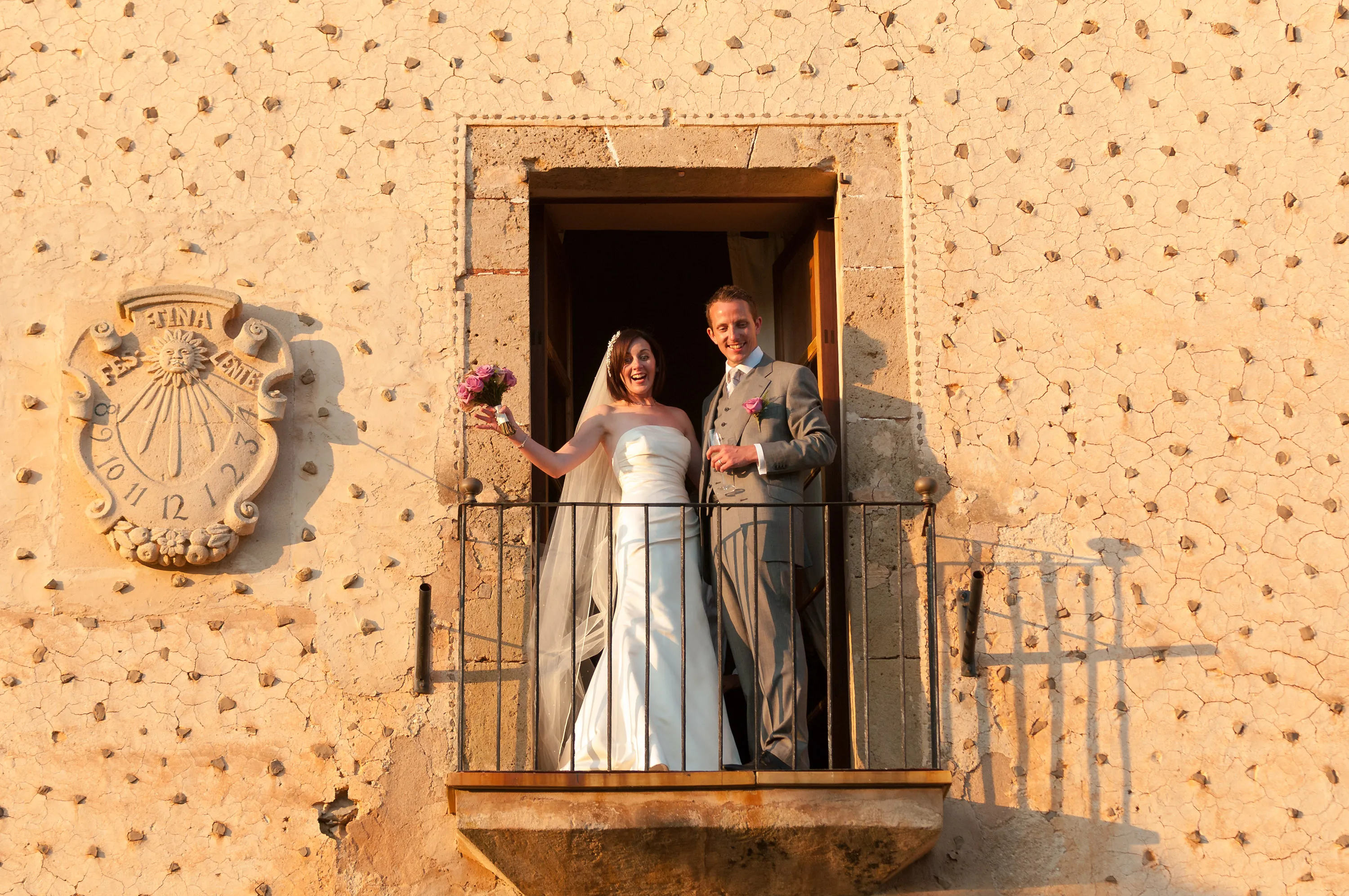 Bride & groom smiling on balcony at Finca Son Bosch