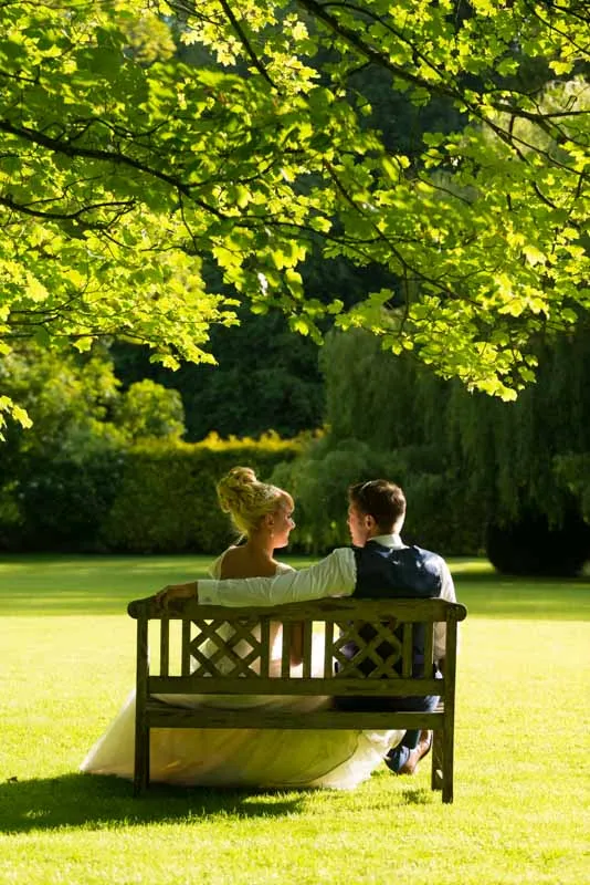 Glen Yr Afon wedding bride & groom on bench