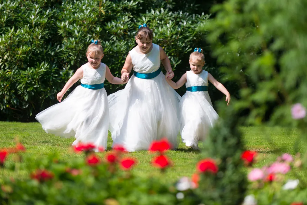 Glen Yr Afon wedding flower girls running on lawn