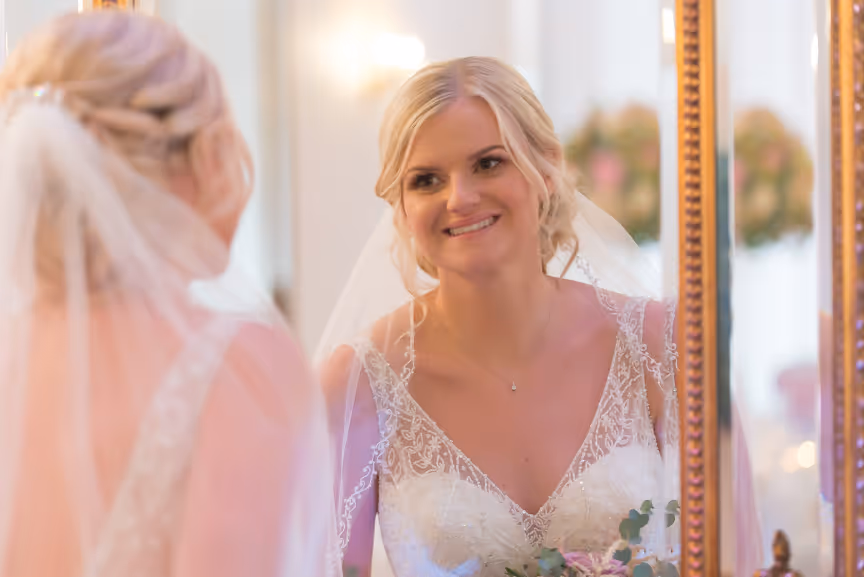 Glen Yr Afon wedding bride looking in mirror in ballroom