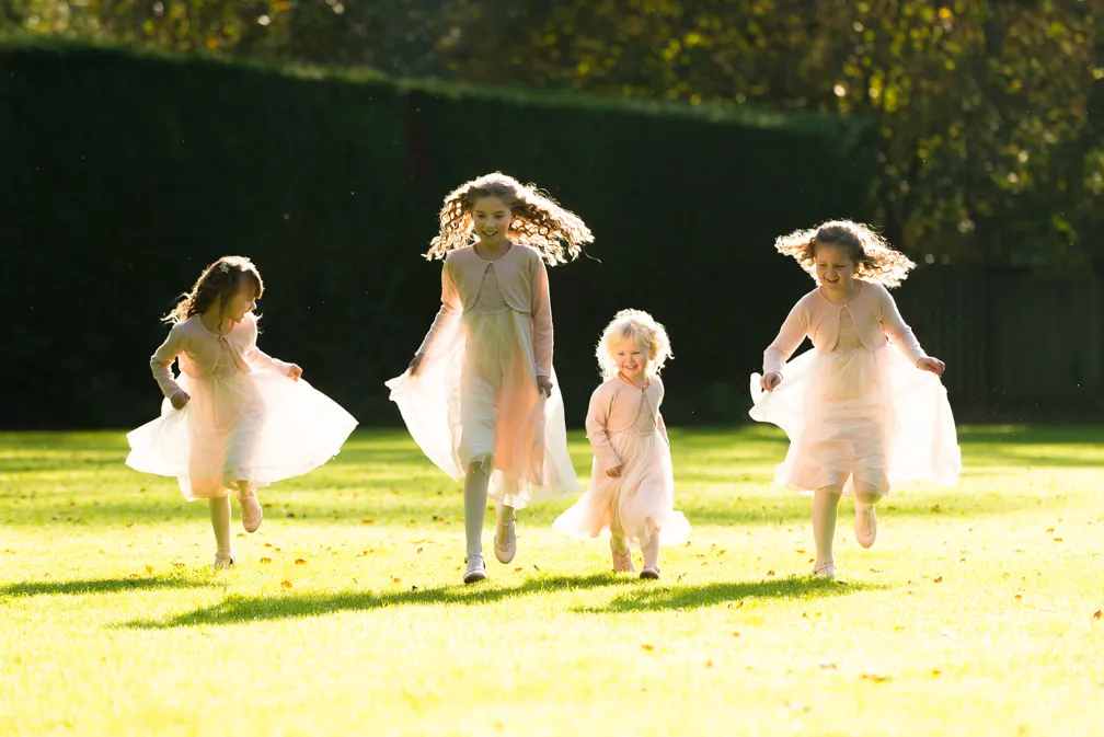 Glen Yr Afon wedding flower girls running in garden