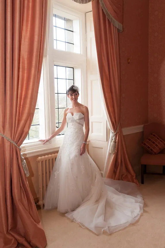 Bride by window at wedding Clearwell Castle