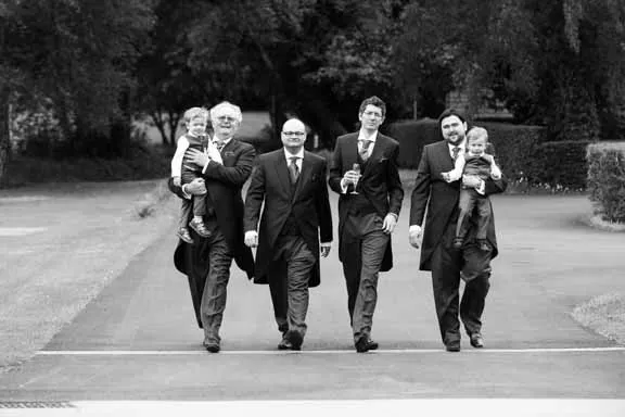 Llangoed hall wedding groom walking down drive