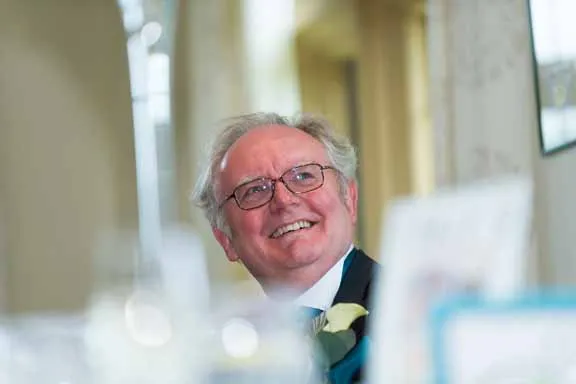 Wedding photographer Andrew Hazard guest laughing during speeches at Llangoed Hall