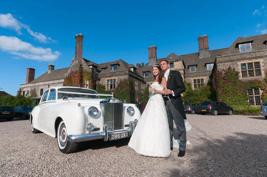 Llangoed hall wedding couple with Rolls Royce