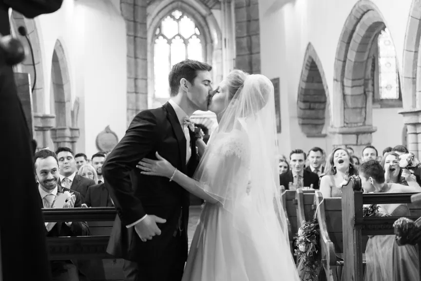 St Tewdrics House wedding bride & groom kissing in church