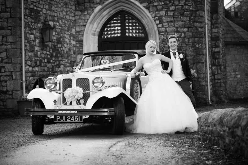 Bride and groom with vintage car at Pencoed House Cardiff