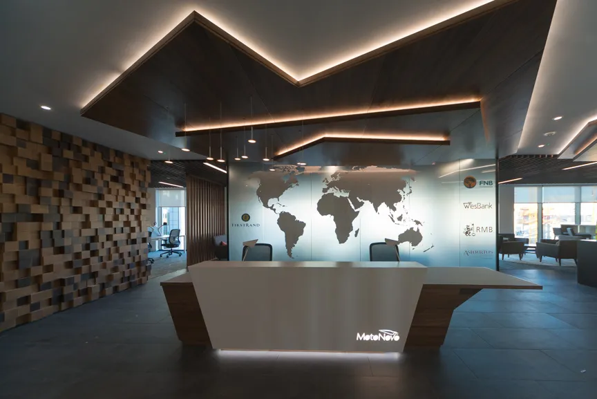 Modern office reception desk with a world map on glass wall and logos of financial institutions on the right.