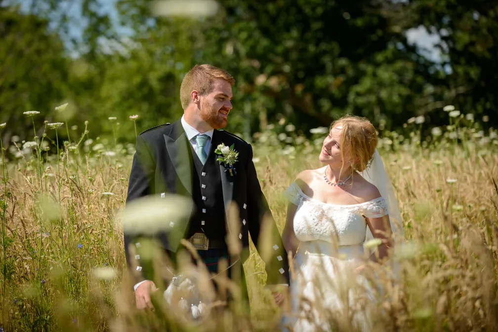 St Tewdrics House wedding bride & groom walking in garden