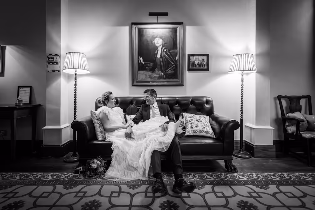Llangoed hall wedding couple sat on Chesterfield 