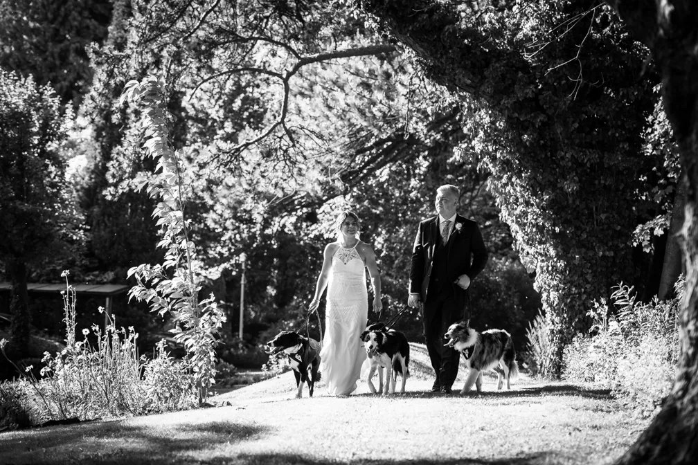Glen Yr Afon wedding bride and groom laughing and dancing on lawn